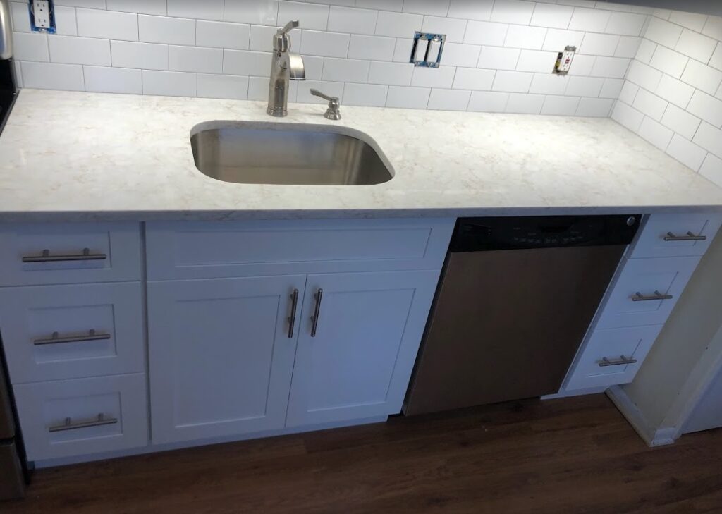 Kitchen remodel in Monmouth County, New Jersey featuring a new undermount sink, white shaker cabinets, subway tile backsplash, updated hardware, and fresh countertops installed by GYB Construction.