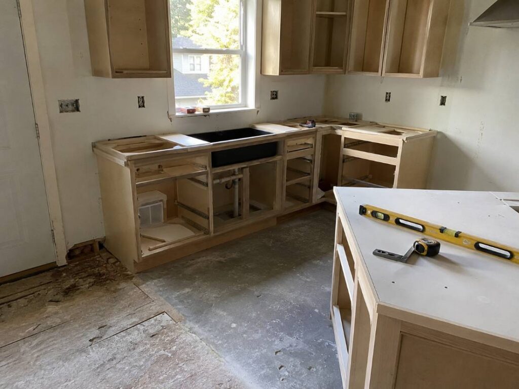 Kitchen renovation in progress showing new cabinetry installation